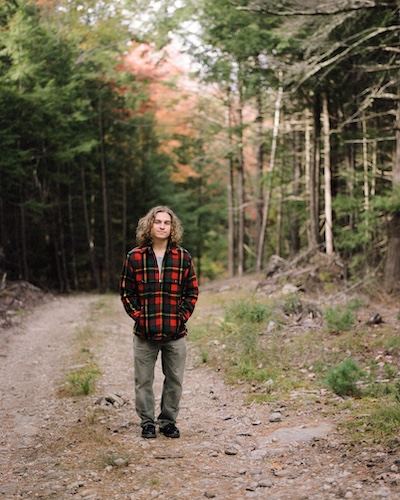 From Norwich to New Orleans - man standing on dirt road with hands in pockets