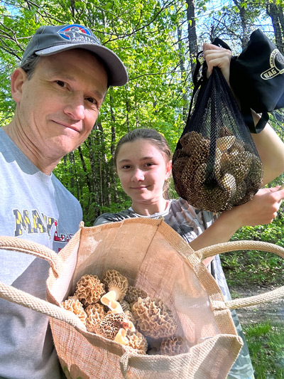 Alden and his daughter Ellicott harvest morel mushrooms in the Upper Valley woods
