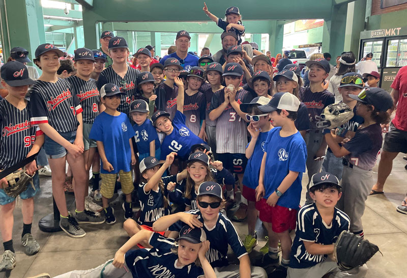 Norwich players of all ages celebrating Youth Sports Day at Fenway Park.
